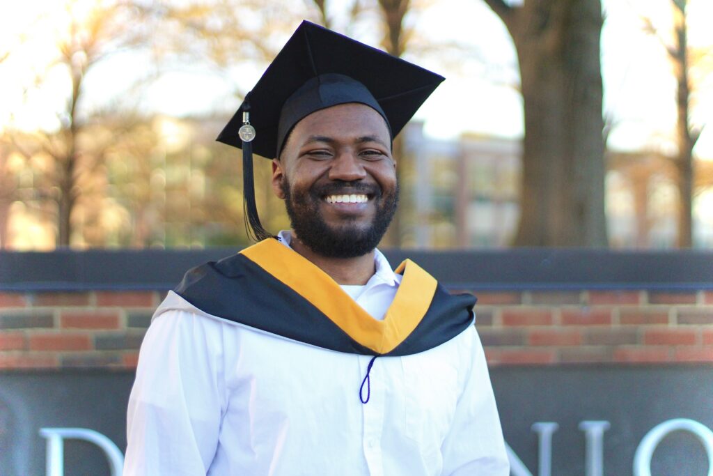 Image of Harris Davis smiling in graduation regalia